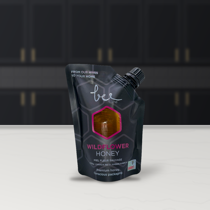 Bee Kind Okanagan Pure Wildflower Honey pouch in a kitchen